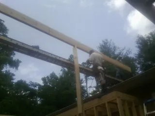 Carpenter setting a ridge beam over a new addition frame — Ice Dam Removal by Roofing Brothers in Portage Des Sioux
