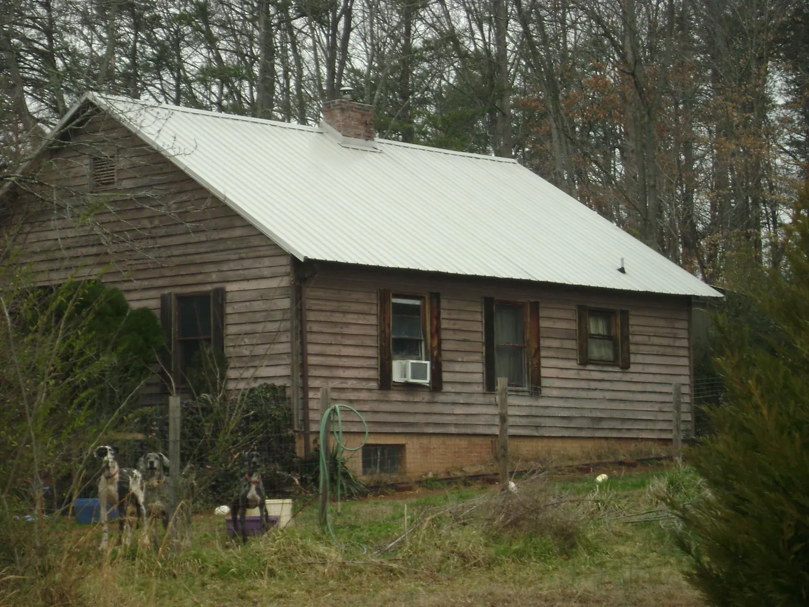 White metal roof on an old wood sided farmhouse, from a Metal Roof Installation job in Portage Des Sioux